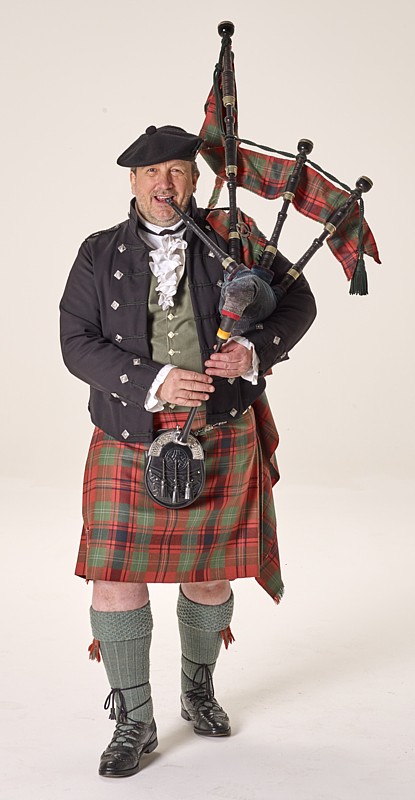 Quest spielt einen große Highland-Dudelsack und trägt schottische Tracht